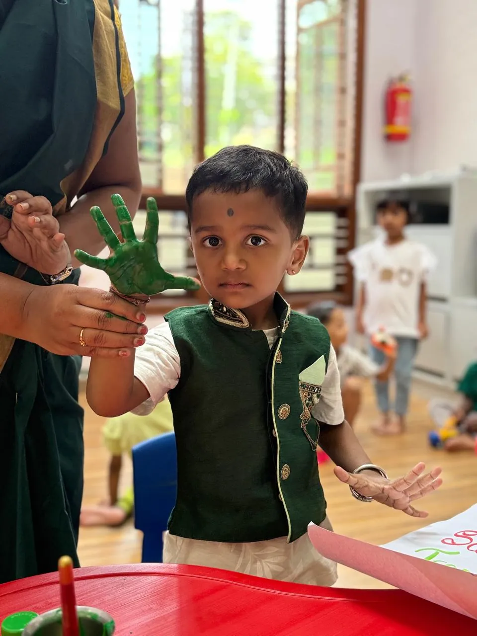 Children engaged in a group activity with teacher